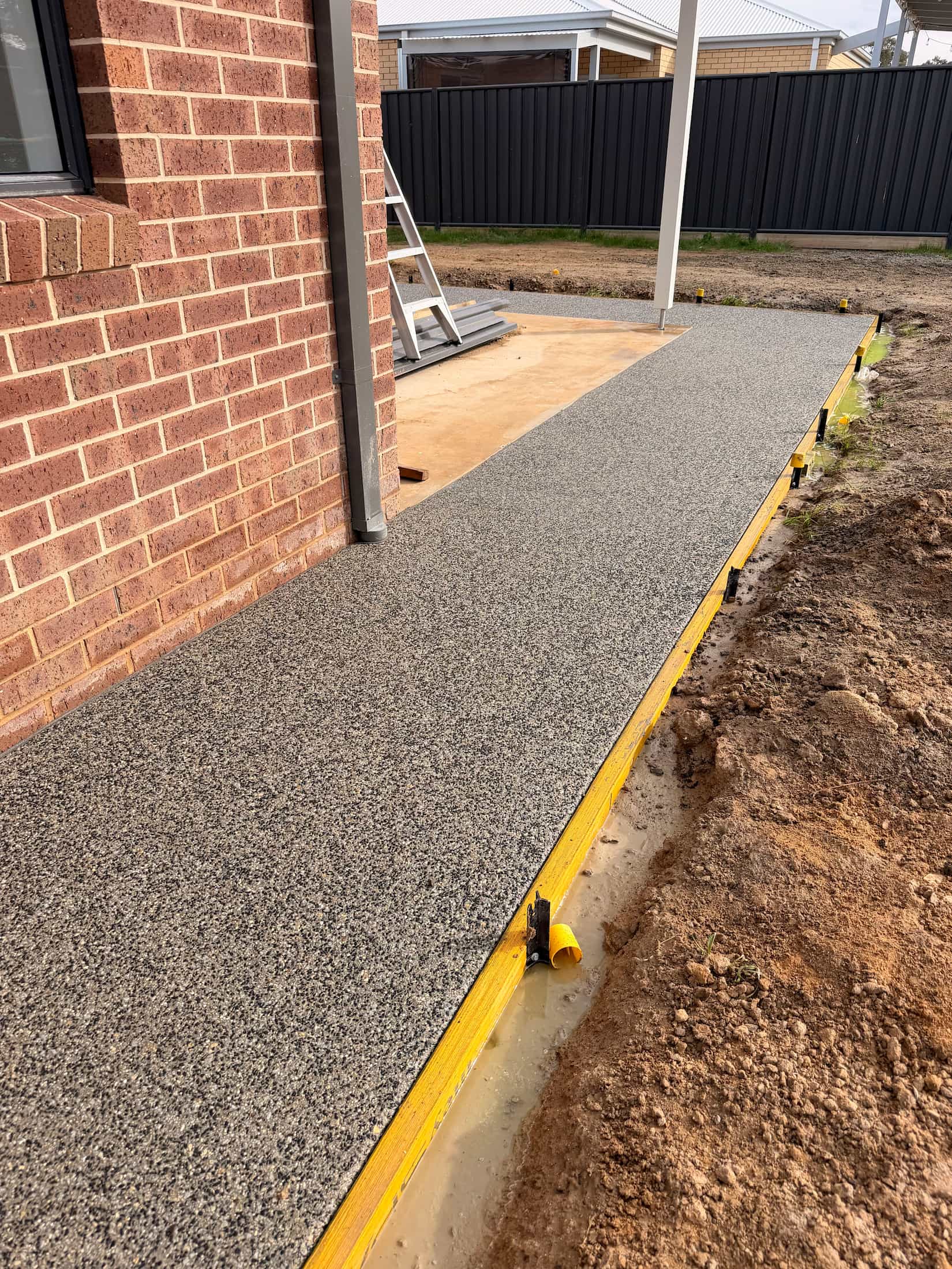 Exposed aggregate concrete path poured in Rochester by KO. Landscapes