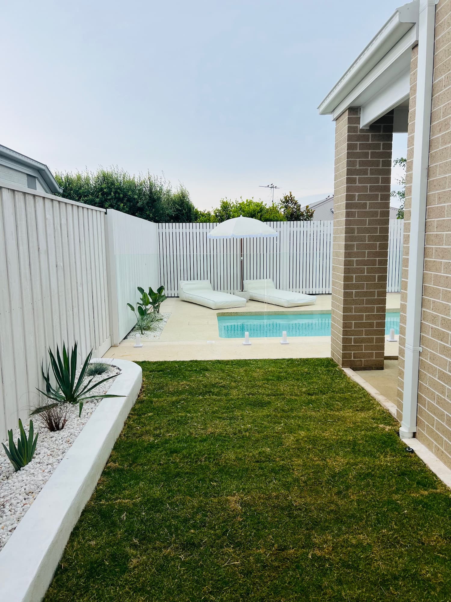 Green lawn and landscaped backyard in Rochester by KO. Landscapes